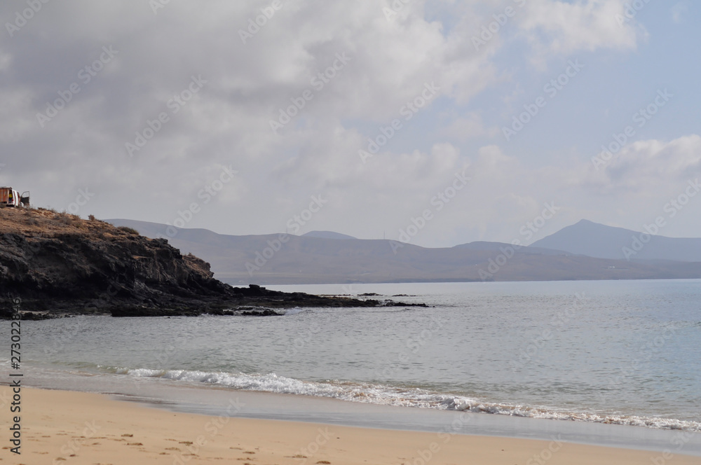 Sandy ocean beach with mountains in background. Costa Calma, Fuerteventura, Canary Islands