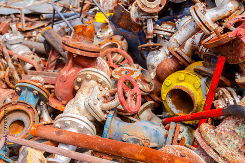 Various aged rusted parts of obsolete equipment at junkyard