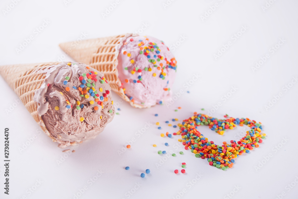 Colorful candies in the shape of a heart and ice cream cones on the white background. Colorful candies in the shape of a heart and ice cream cones on the white background.