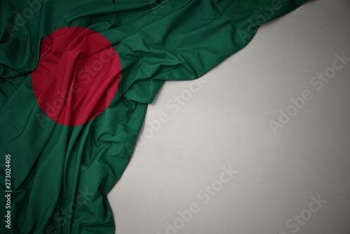 waving national flag of bangladesh on a gray background. photo