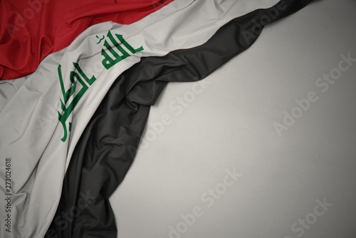 waving national flag of iraq on a gray background. photo