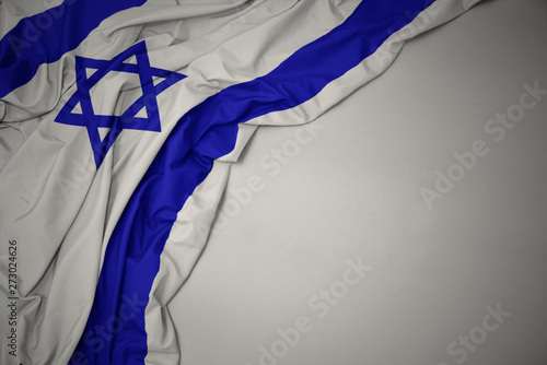 Fotografia waving national flag of israel on a gray background.