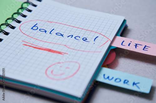 Work life balance choice concept. Stickers with inscriptions in a notebook.