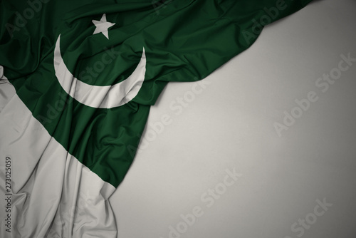 waving national flag of pakistan on a gray background.