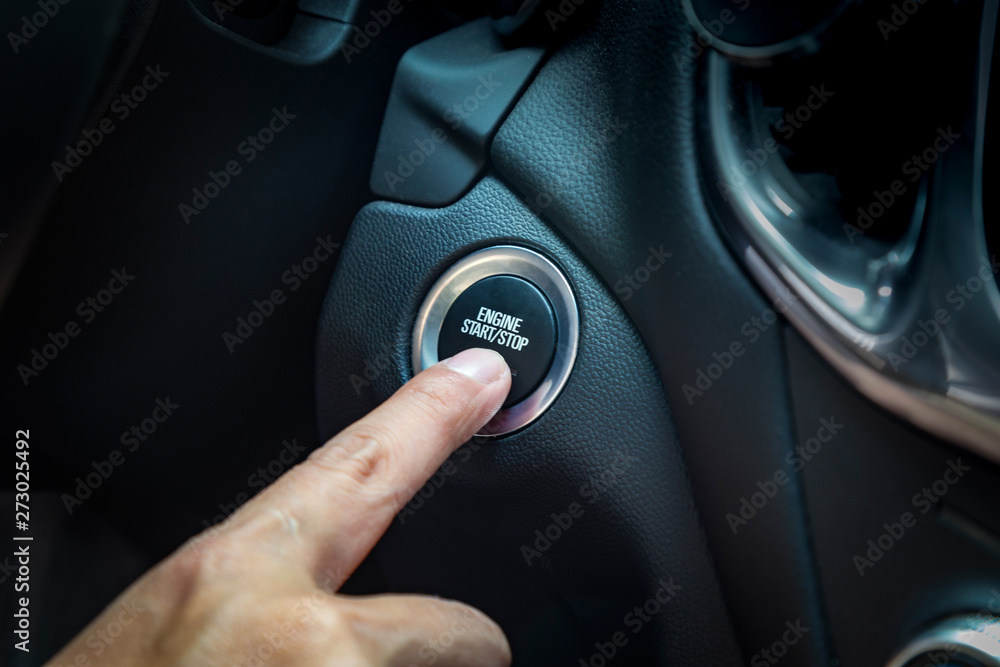 hand pushing a button to start car engine hand pushing a button to start car engine
