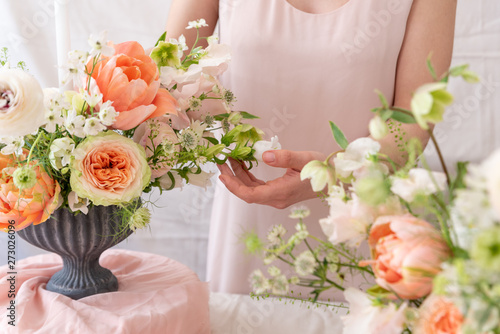 Woman hands touching a bouquet of flowers.