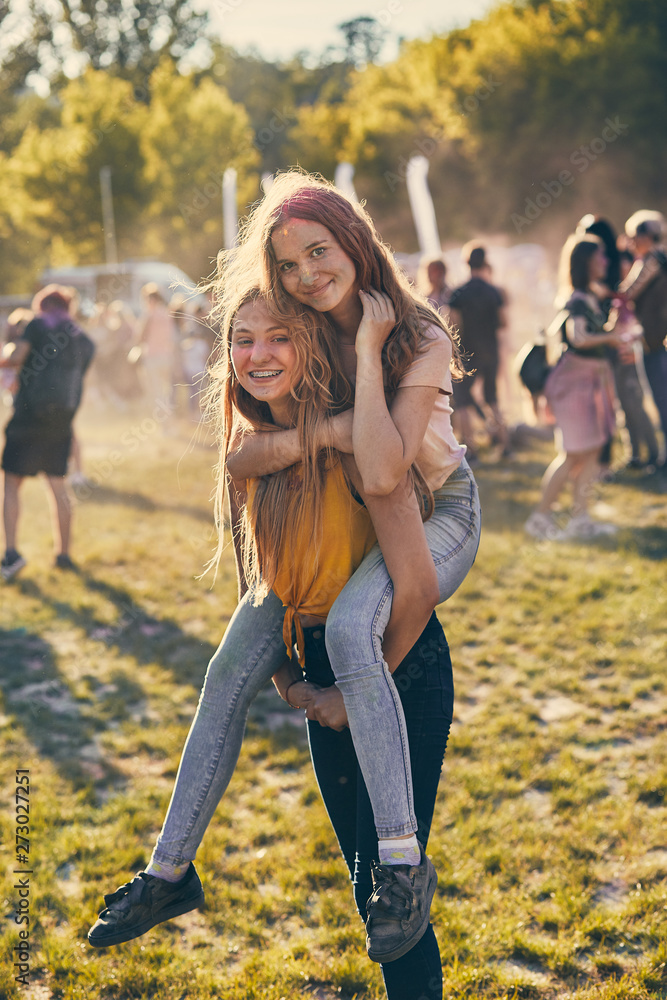 Fototapeta premium Portrait of happy young girls on holi color festival