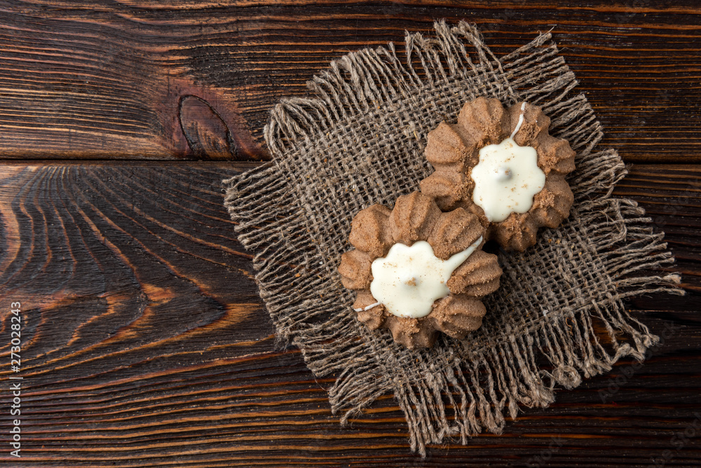 Chocolate shortbread cookies on dark wooden background.