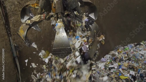 Crane depositing Garbage in an Industrial Dumpster. Wast Recycling Plant