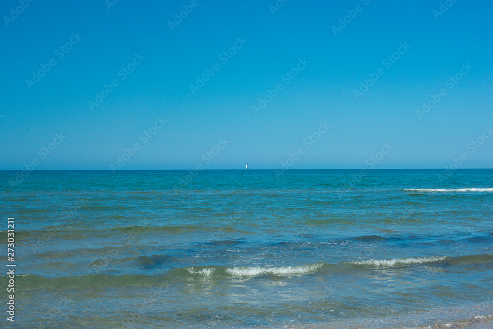 the blue sky over the calm sea with the reflection of sunlight. Calm sea harmony of calm water surface. Sunny sky and calm blue ocean.