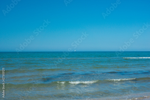 the blue sky over the calm sea with the reflection of sunlight. Calm sea harmony of calm water surface. Sunny sky and calm blue ocean. © Pavel
