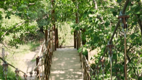 Looking down to the river from a suspension bridge. First person view