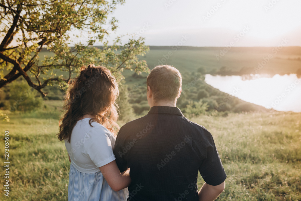 young couple man and woman look together into the green distance young couple man and woman look together into the green distance