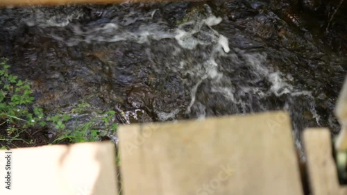 Looking down to the rapids from a suspension bridge. First person view