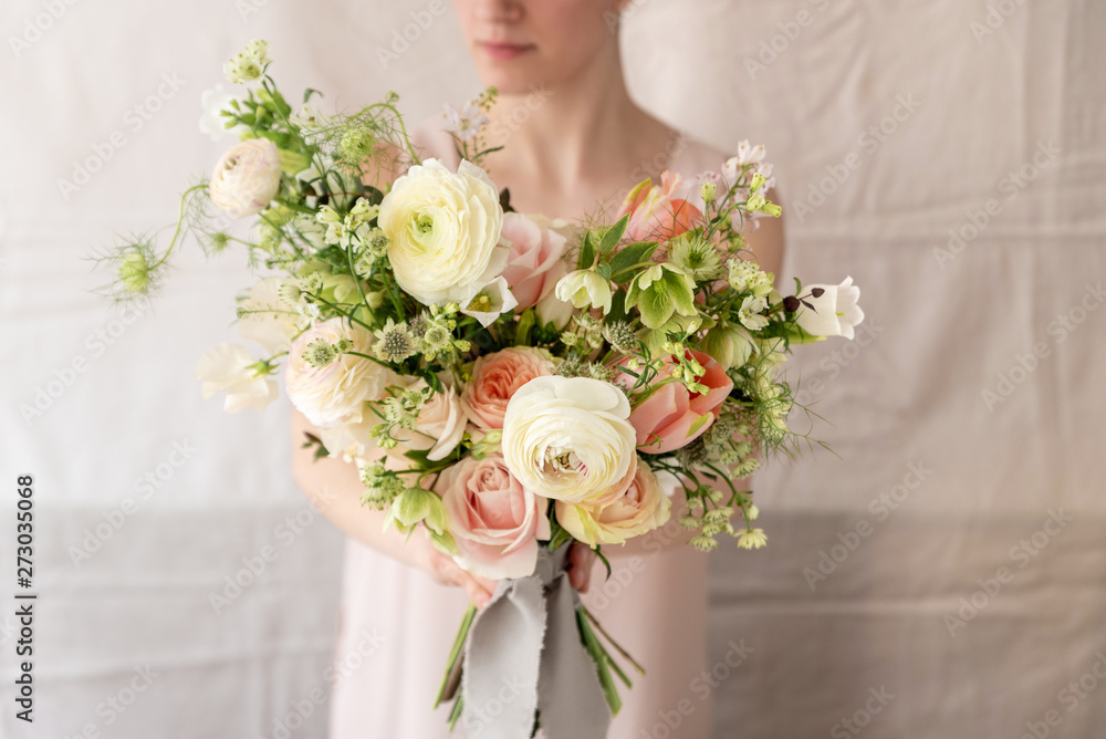 Woman holding a bouquet of flowers.