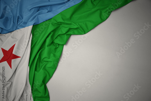 waving national flag of djibouti on a gray background. photo