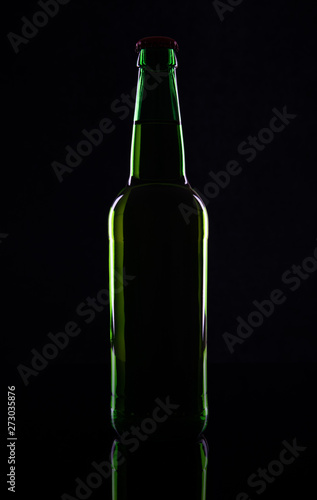 Green beer bottle, isolated on black background