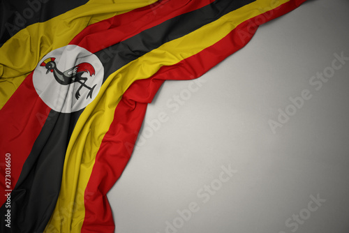 Tablou pe pânză waving national flag of uganda on a gray background.