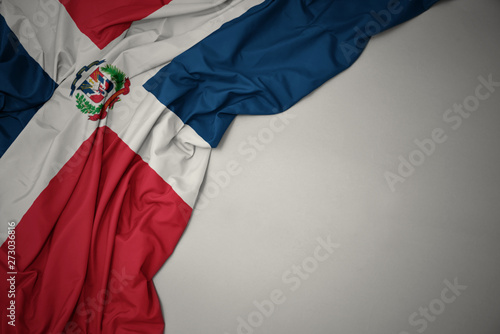 waving national flag of dominican republic on a gray background. photo