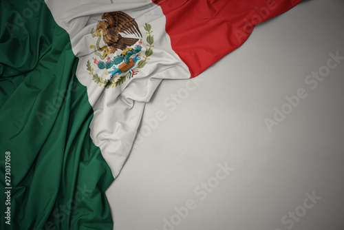 waving national flag of mexico on a gray background. photo