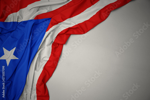 Bild auf Leinwand waving national flag of puerto rico on a gray background.