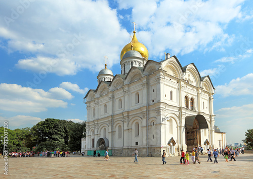Excursion group of foreign tourists on the background of the Archangel Cathedral of the Moscow Kremlin