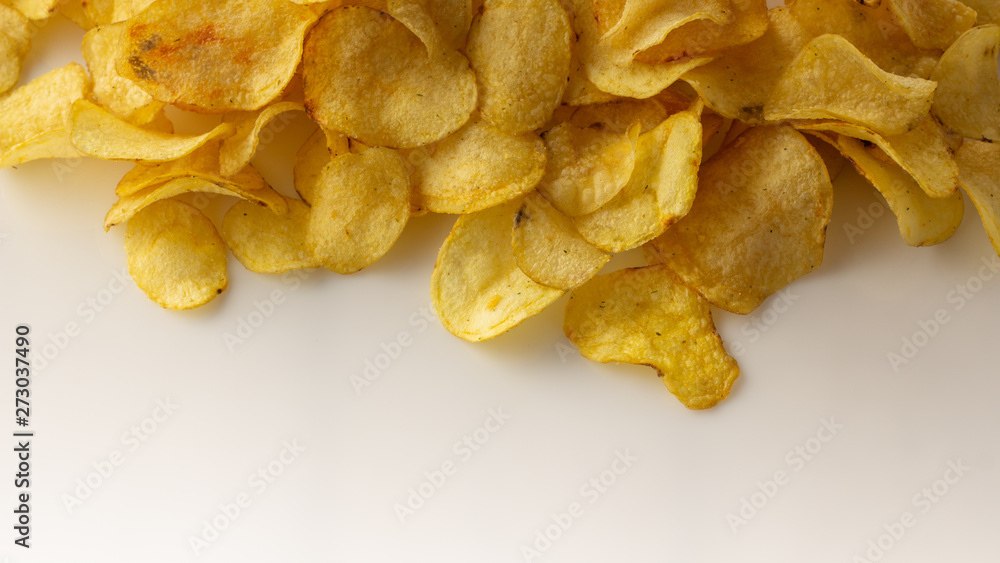 golden brown potato chips on a white background.