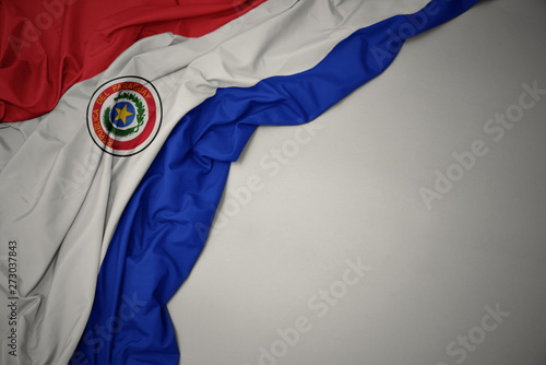 waving national flag of paraguay on a gray background. photo