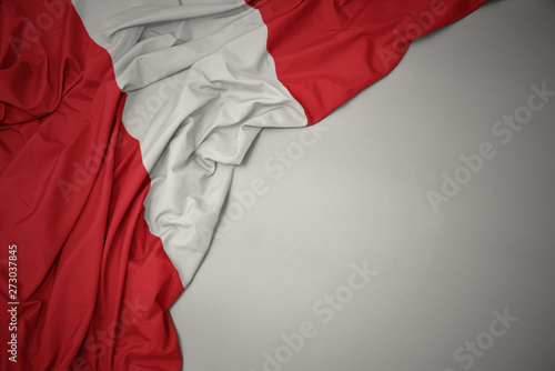 Fotografi waving national flag of peru on a gray background.