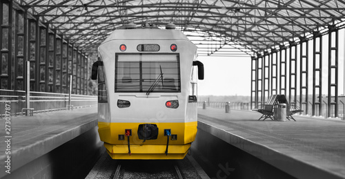 White-yellow shuttle railbus stand on airport rail station photo