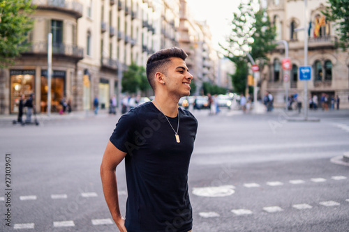 Young fashionable handsome man on the street of modern city. He looks happy © Igor Kardasov