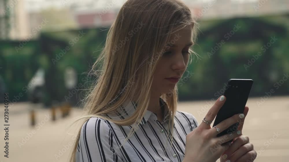 Woman student walking city outdoor call phone, talking phone audio message happy girl skyscrapers on background Woman student walking city outdoor call phone, talking phone audio message happy girl skyscrapers on background