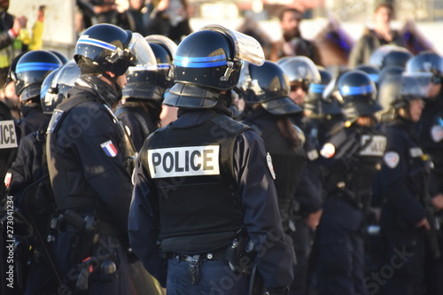 Fotobehang Helmeted police officers photographed from behind during a protest
