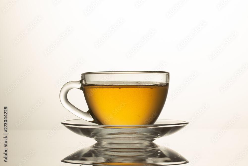 cup of herbal tea with chamomile flowers on a white table cup of herbal tea with chamomile flowers on a white table
