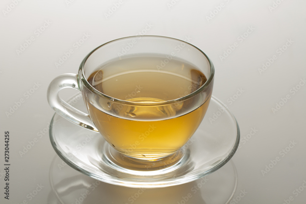 cup of herbal tea with chamomile flowers on a white table cup of herbal tea with chamomile flowers on a white table