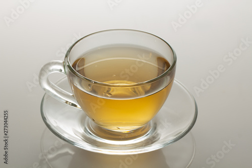 cup of herbal tea with chamomile flowers on a white table