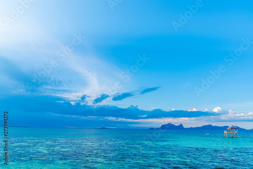 Tropical background turquoise sea and blue sky