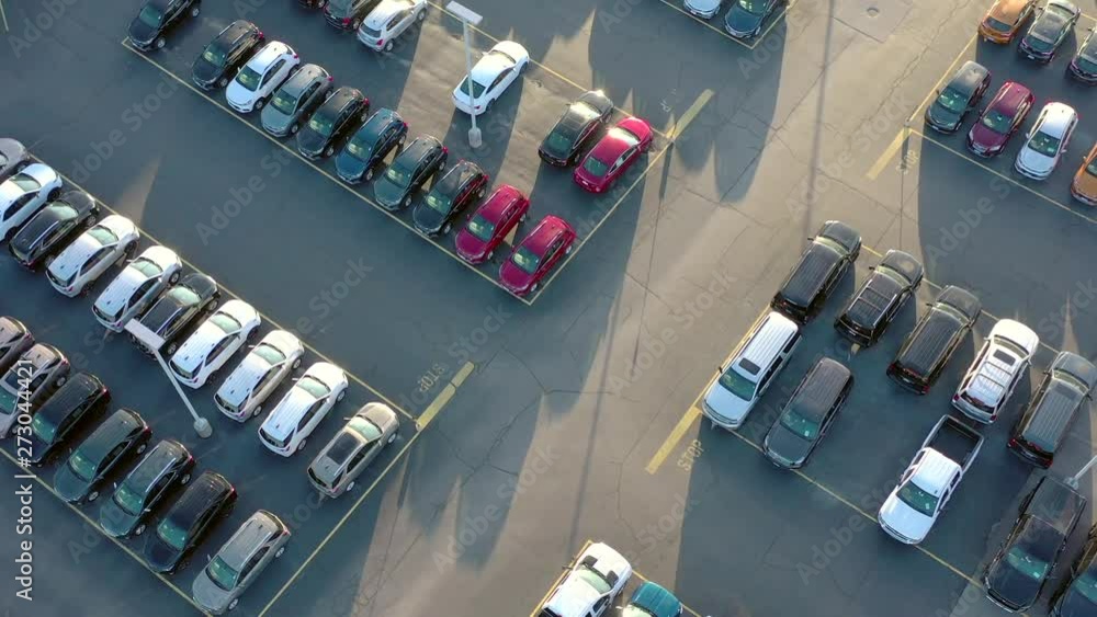 New cars and trucks for sale, large automobile dealership in Springtime, aerial view. New cars and trucks for sale, large automobile dealership in Springtime, aerial view.