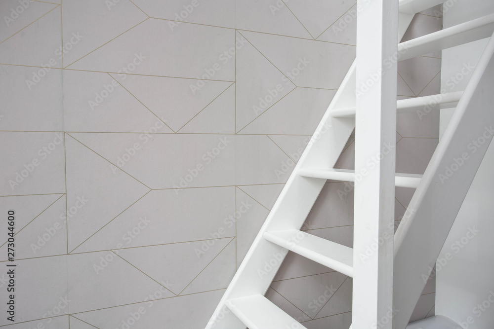 Stairs in modern white room, white wooden stairs with white wall retro wallpaper Stairs in modern white room, white wooden stairs with white wall retro wallpaper