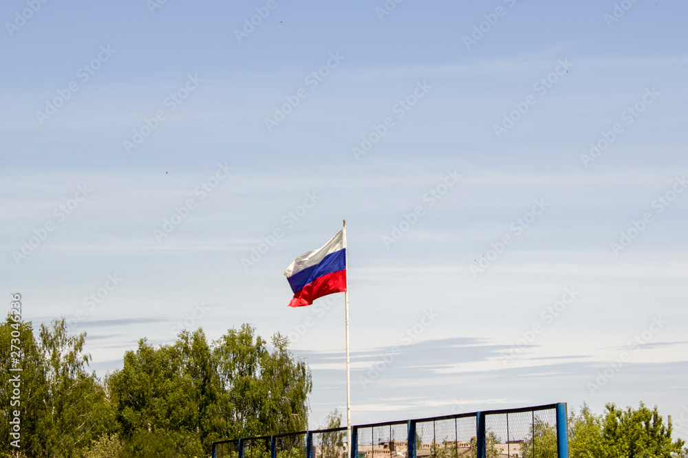 Fototapeta premium flag of the Russian Federation on a flagpole against the sky