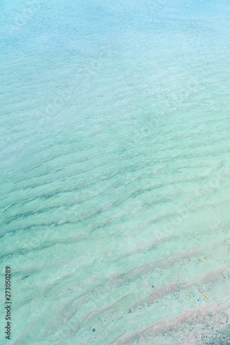 Colorful sand on tropical beach. Copy space.