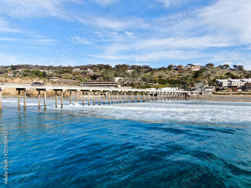 Aerial view of the scripps pier institute of oceanography, La Jolla, San Diego, California, USA. Research pier used to study ocean conditions and marine biology. Pier with luxury villa on the coast.