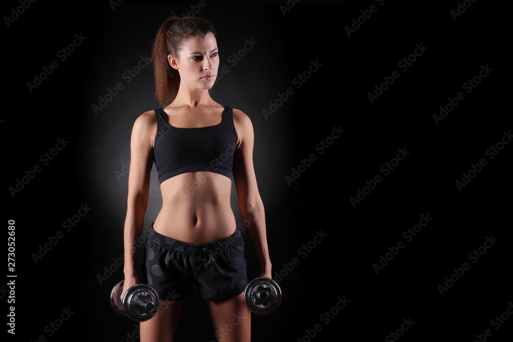 Beautiful fitness woman lifting dumbbells Beautiful fitness woman lifting dumbbells