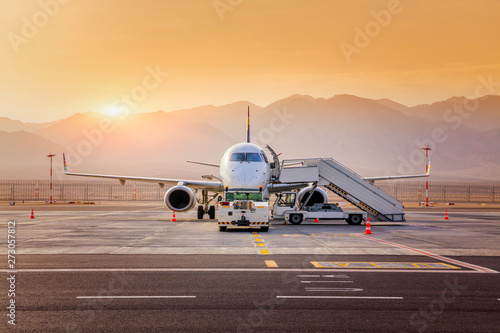 Airplane at sunrise in the New Ramon International Airport in Eilat, Arava desert, Israel, Waiting for the flight.