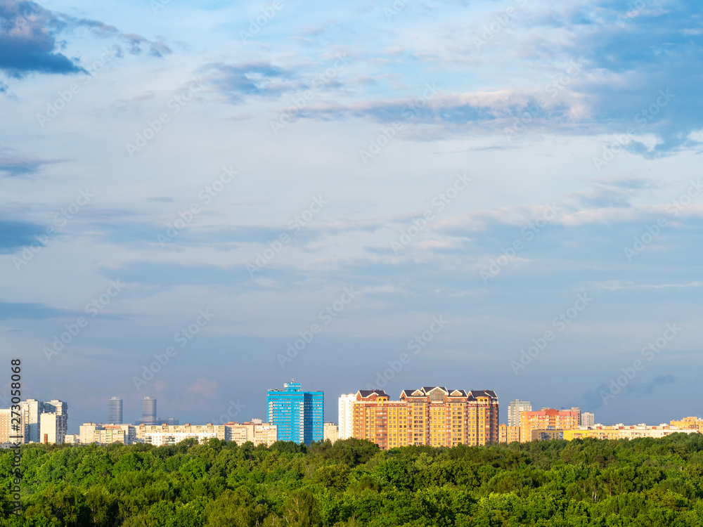 dark blue sky over city park and urban houses dark blue sky over city park and urban houses
