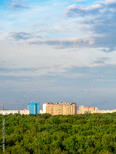 evenig sky over city park and residential houses