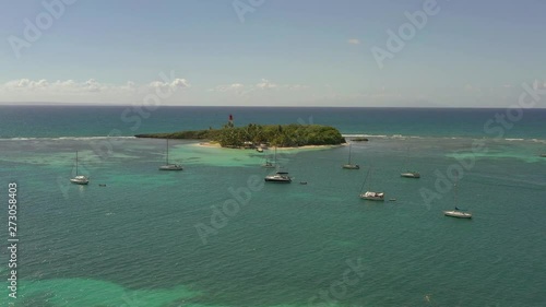 Scenic aerial view of Le Gosier island  near La Datcha beach in Guadeloupe. Beautiful summer sunny look of small paradise tropical island in Caribbean sea. Several boats and yachts in blue sea.