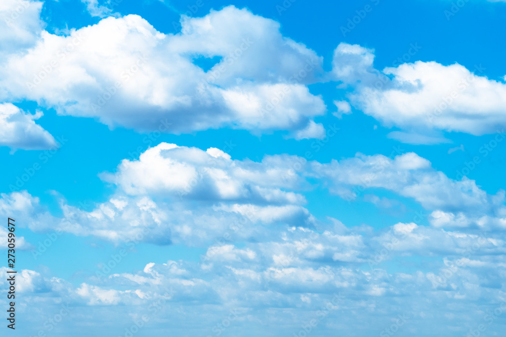Fototapeta premium many white fluffy clouds in blue sky in May