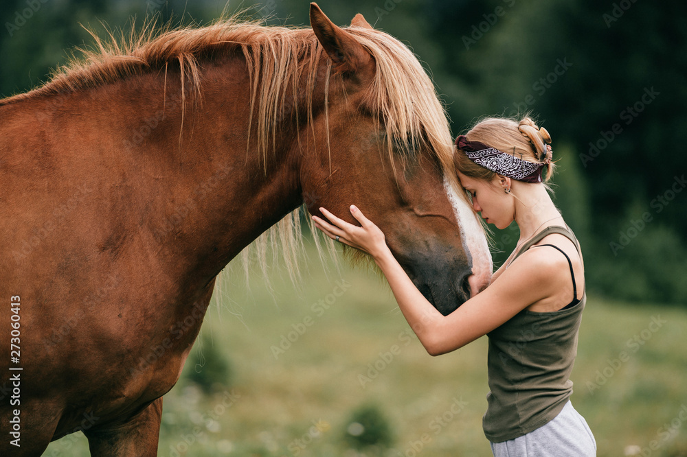 Young beautiful girl hugging horse at nature. Horse lover. - obrazy, fototapety, plakaty 