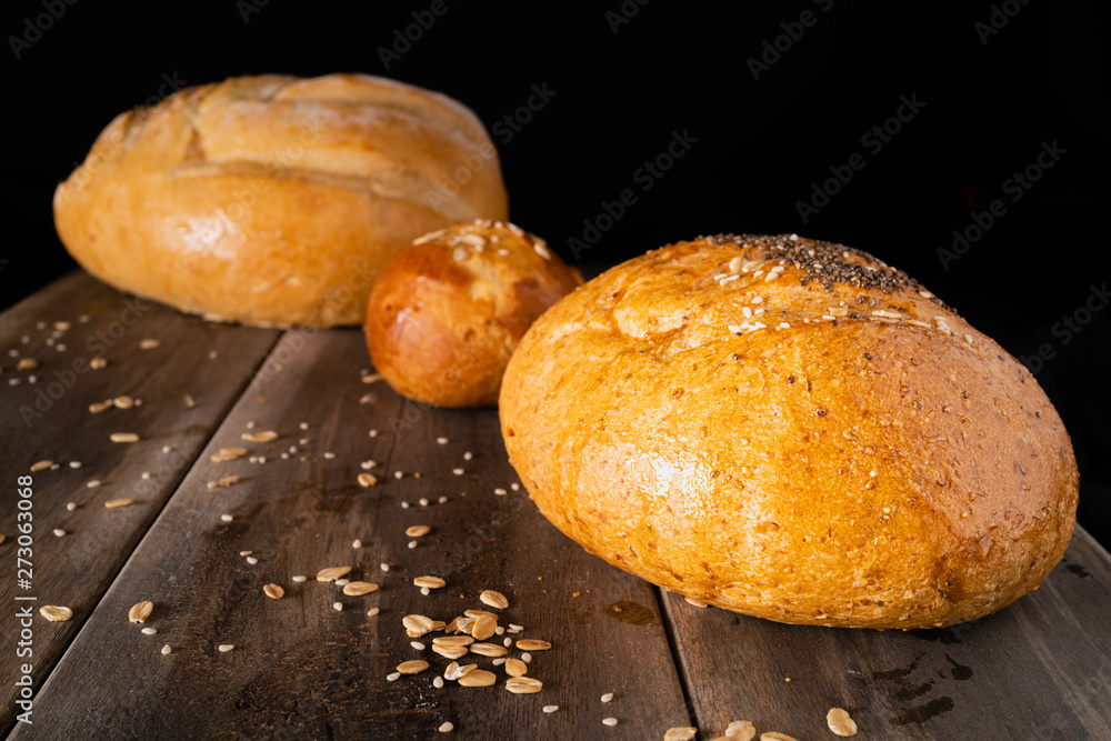 Three loaves on an old wooden table Three loaves on an old wooden table